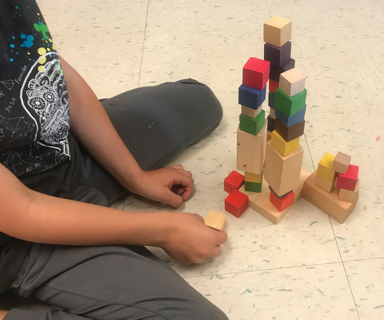 Student towers with solid blocks of various colors. 