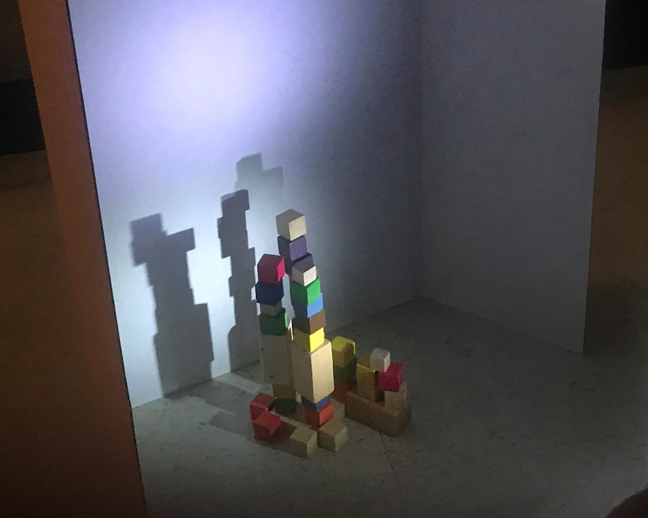 Exploring the shadows created by different-colored solid blocks.